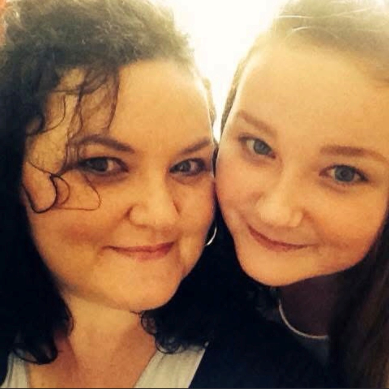 Photo of Patricia and her daughter Aofie standing in front of a Christmas tree looking happy