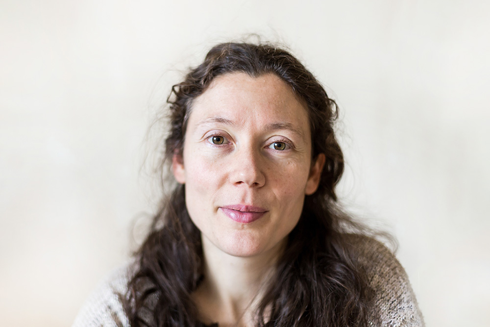 Stock image of Hannah, a woman in her 40s with long dark hair and wearing a cream cardigan